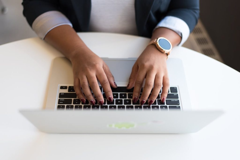 pexels photo 1181441 Woman's hands typing on a wireless laptop at a modern office desk, highlighting technology in business.